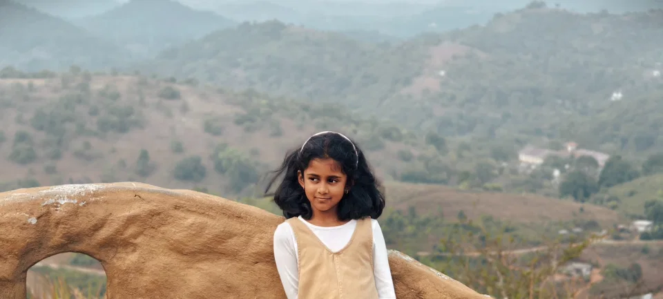 Siya smiling outdoors in the hills